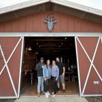 goathouse brewing in lincoln, founder johnsons with new owners mattie and brain place in front of the converted barn