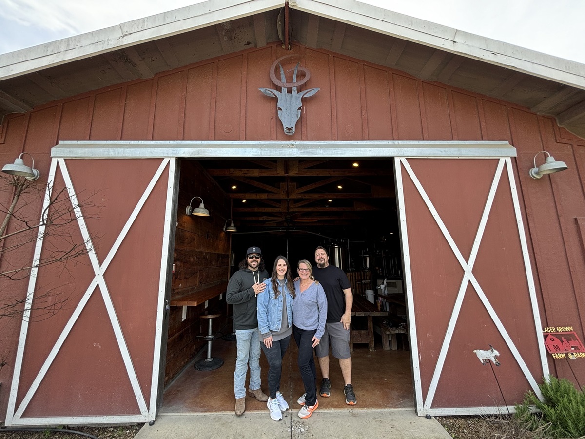 goathouse brewing in lincoln, founder johnsons with new owners mattie and brain place in front of the converted barn