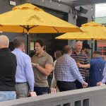 What Now Media Group CEO and Founder Caleb J. Spivak (center) mingles with DFW's building restaurateurs on the expansive Postino Addison patio.