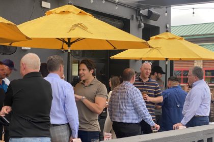 What Now Media Group CEO and Founder Caleb J. Spivak (center) mingles with DFW's building restaurateurs on the expansive Postino Addison patio.