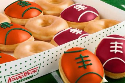 The limited-edition box features football-shaped doughnuts in vibrant team colors along with the company’s classic Original Glazed