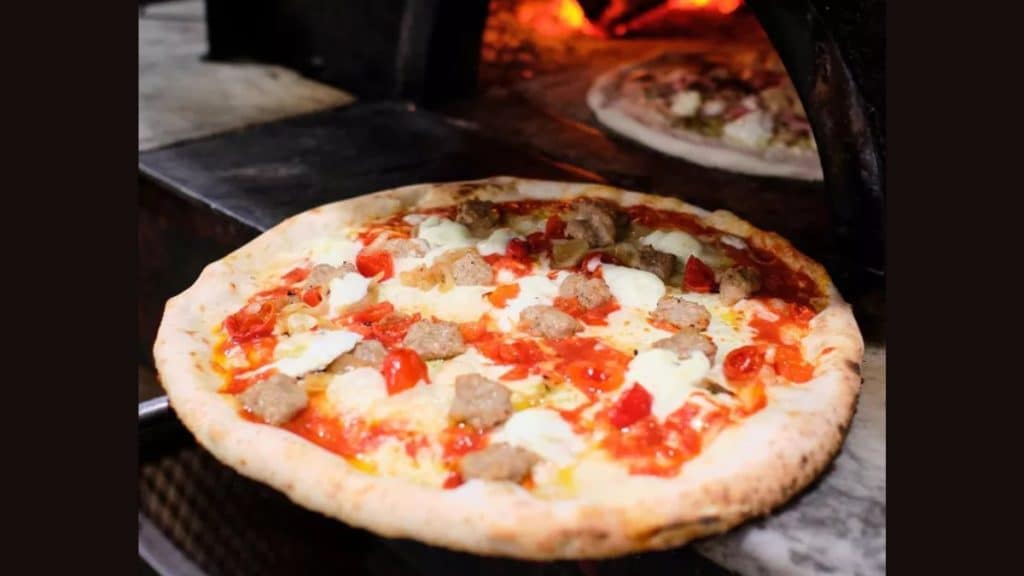 Image of pizza ready to be baked at Antico Pizza Napoletana, featured in the Michelin Guide (Source: guide.michelin.com)
