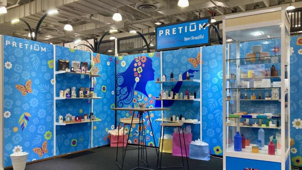 This image shows a booth by Pretium Packaging, which has its jars, bottles, closures and folding cartons.