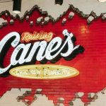 This image shows Raising Cane's brick sign.