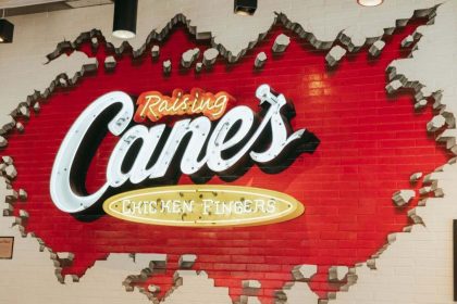 This image shows Raising Cane's brick sign.