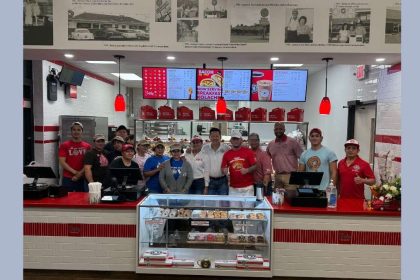 ​This image shows employees posing for a picture at the Rosharon location of Shipley Do-Nuts.
