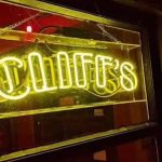 Lit-up sign that says Cliffs in neon yellow