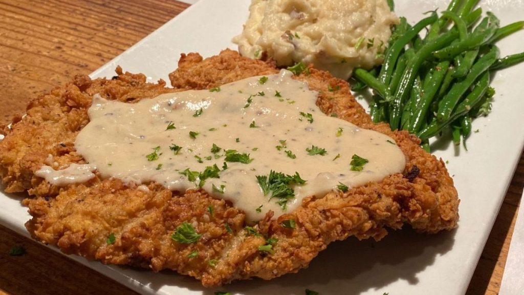 The menu of the restaurant is focused on comfort food and mesquite-grilled meats (Image credit: theravengrill.com)