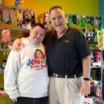 John Cronin and his father pose for a picture at the new store