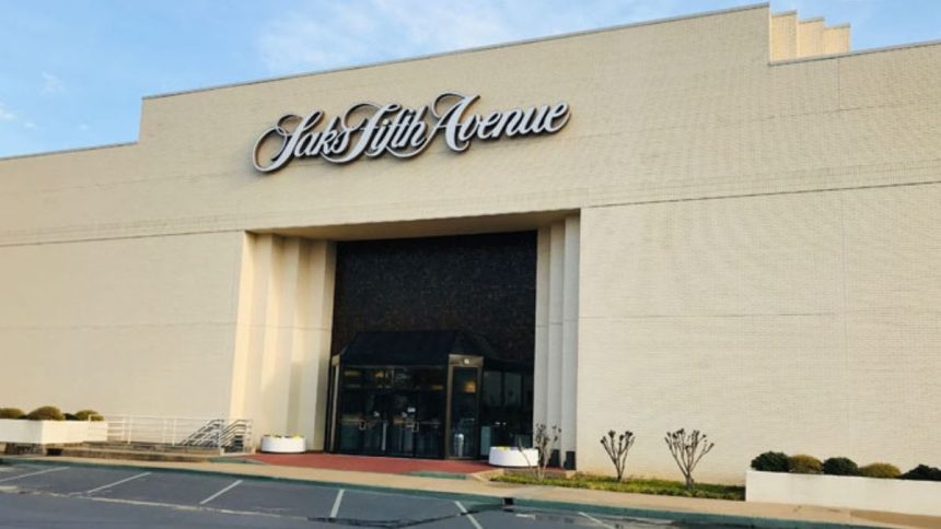 This image shows a storefront view of Saks Global