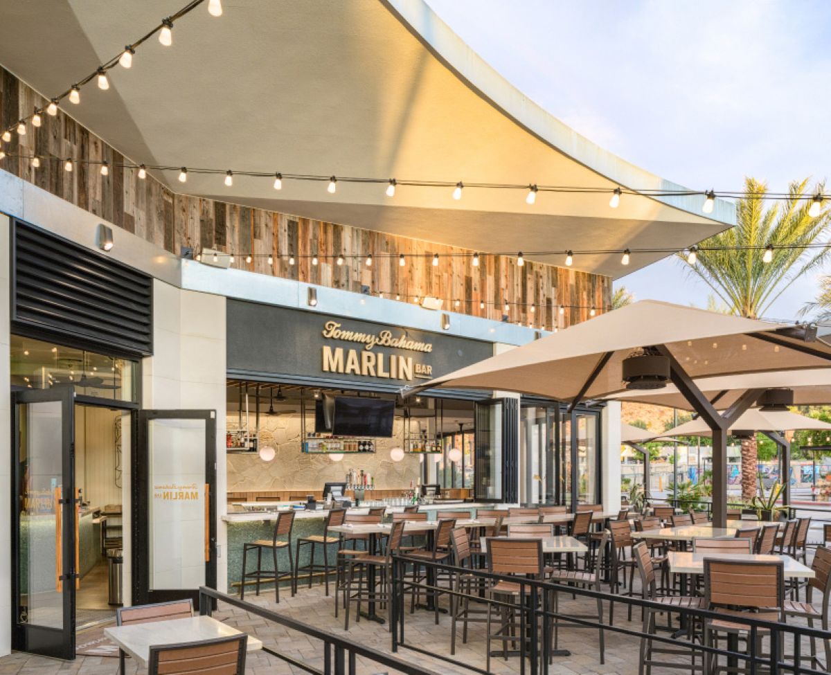 Known for tropical cocktails, seafood-forward bites, and "toes in the sand" vibes